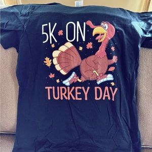 Woman’s size large black t-shirt. Selling because I couldn’t decide on a size.
